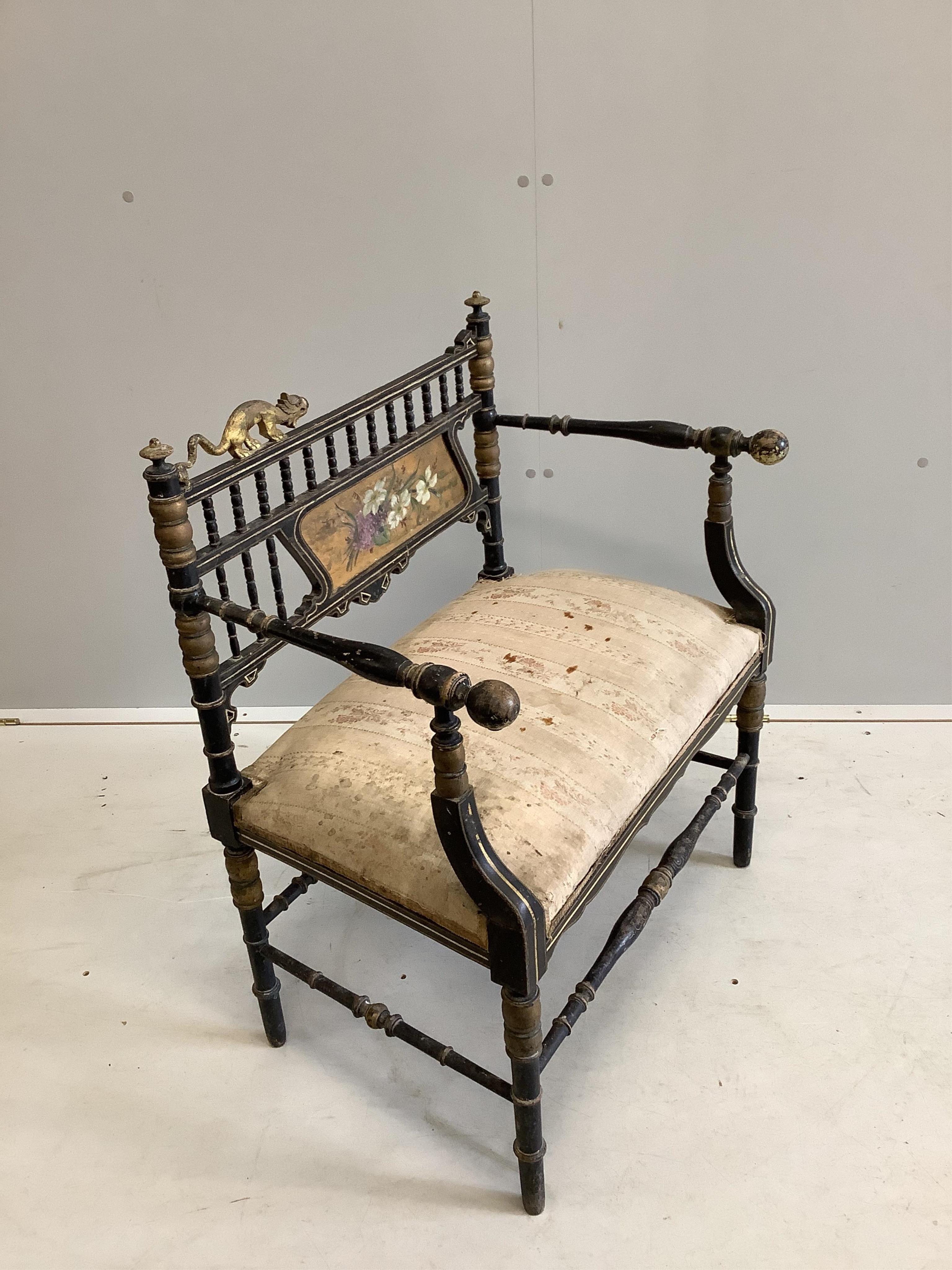 A Napoleon III Aesthetic movement ebonised salon chair, with gilt decoration and carved with the figure of a stylised beast on the cresting rail, width 67cm, height 81cm. Condition - poor to fair